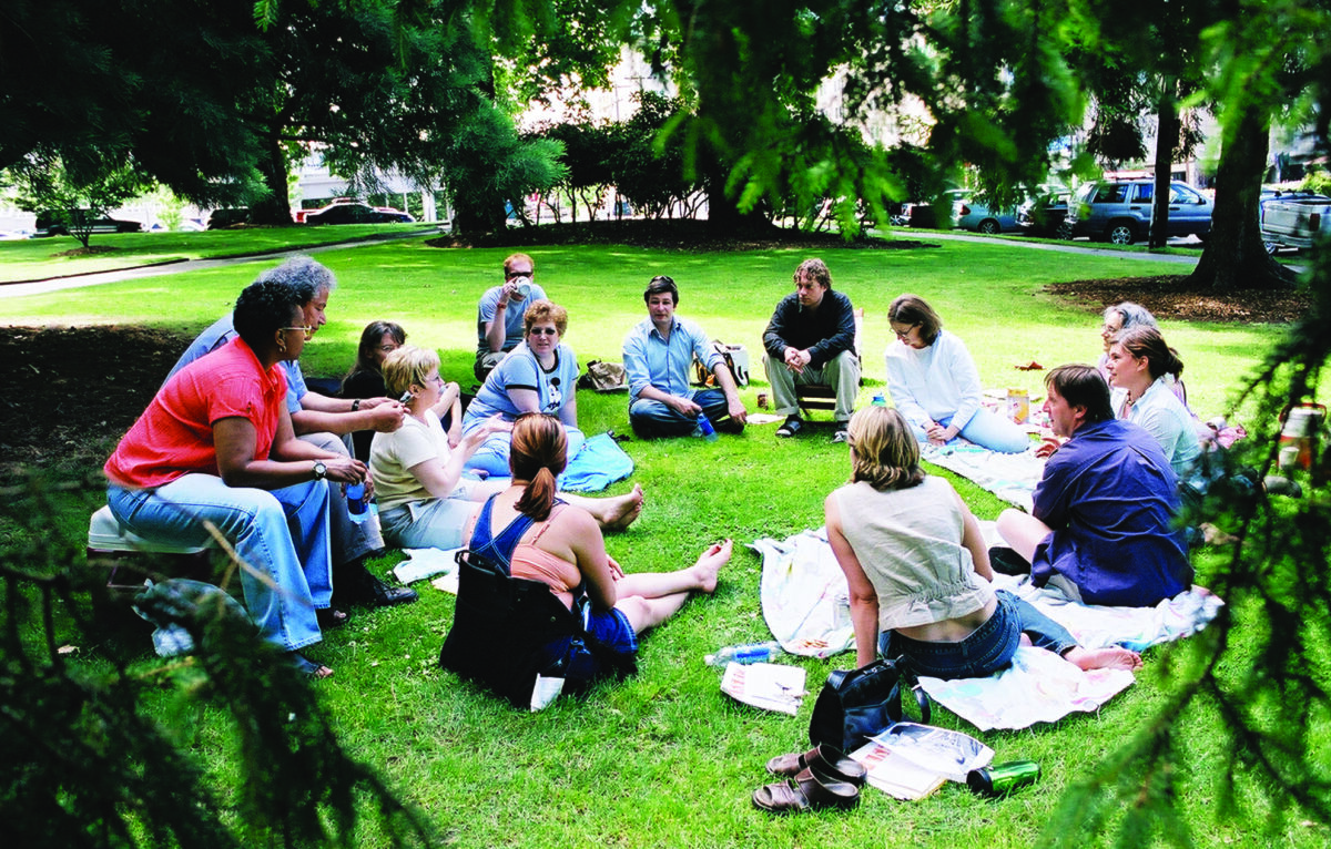 students, students sitting in the grass in a circle