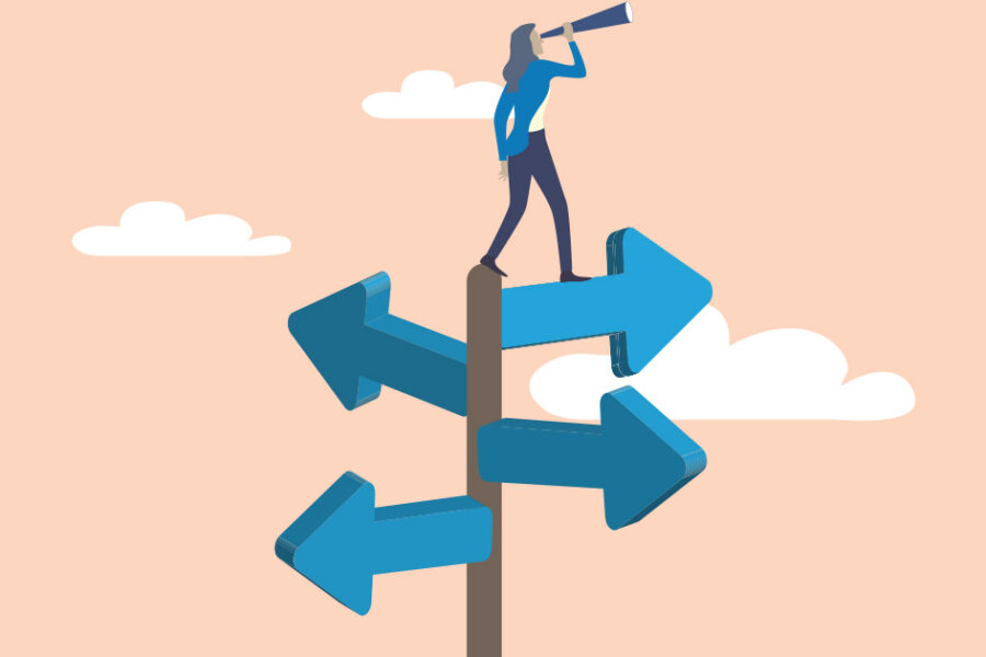 Person standing on a multi-direction signpost, looking through a telescope to plan the path ahead.