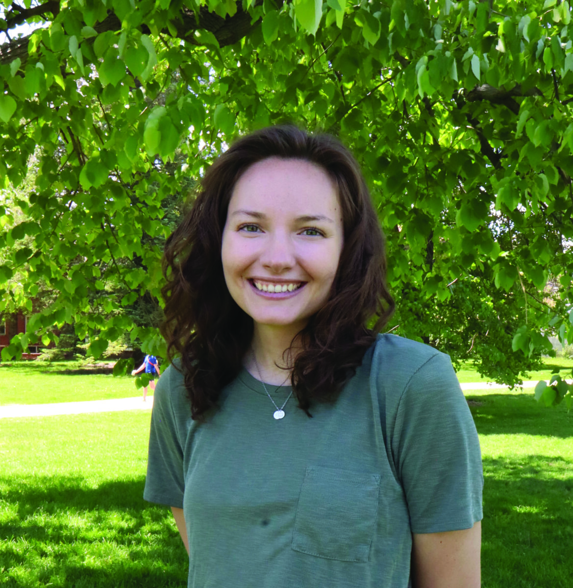 Taylor Hardock, woman smiling green shirt in the trees, trees, green, brown hair, smile