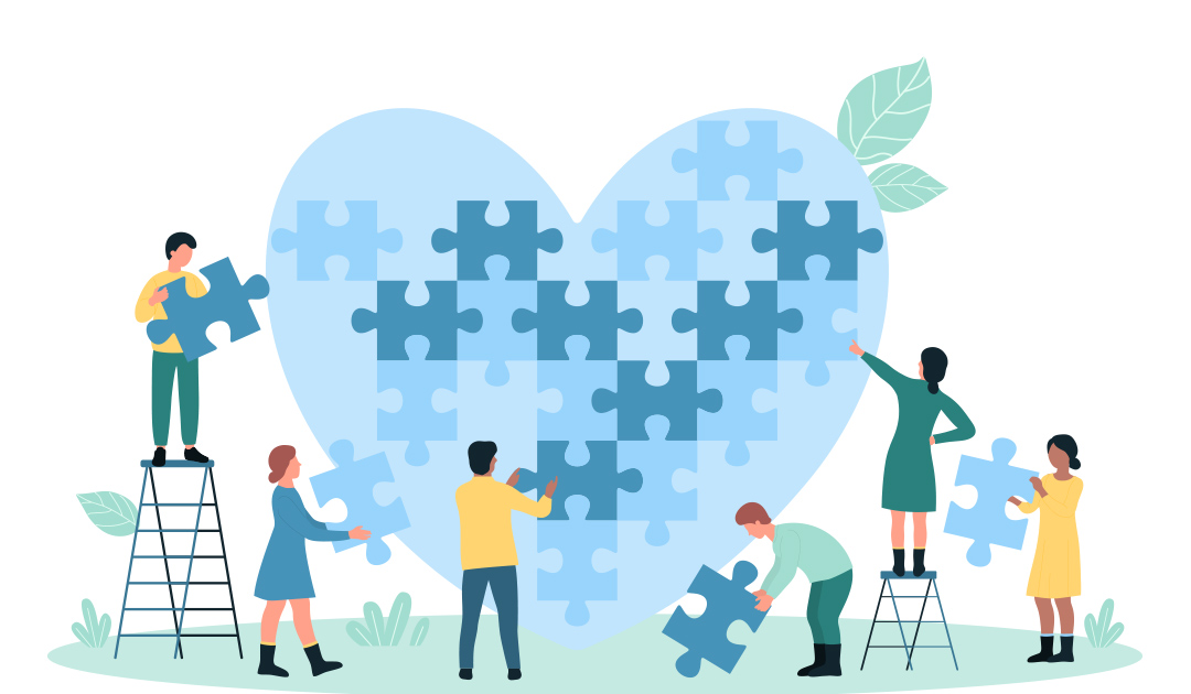 Six people work together to assemble a large heart-shaped puzzle